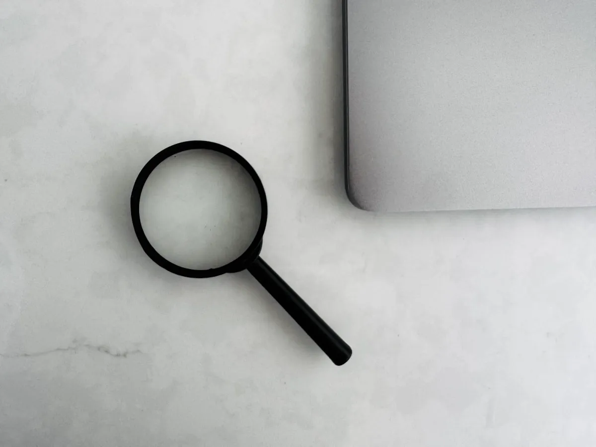 Open notebook and laptop used for writing QuickBooks troubleshooting guides