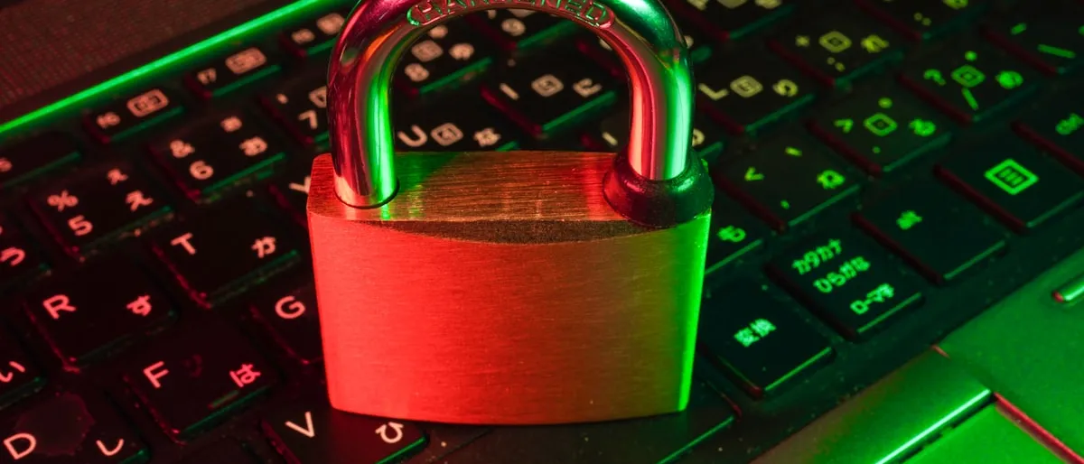 A padlock resting on a laptop keyboard, representing a license lock