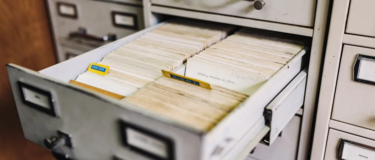 An open file cabinet drawer full of paper records