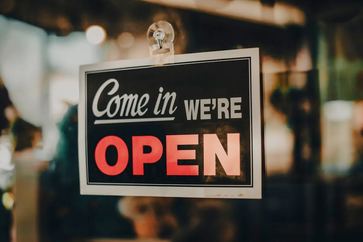An "open" sign in a small business storefront window