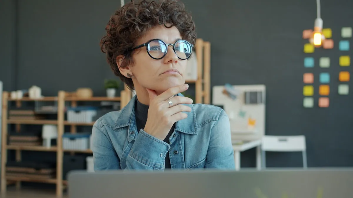 A person thinking through a QuickBooks problem at a desk