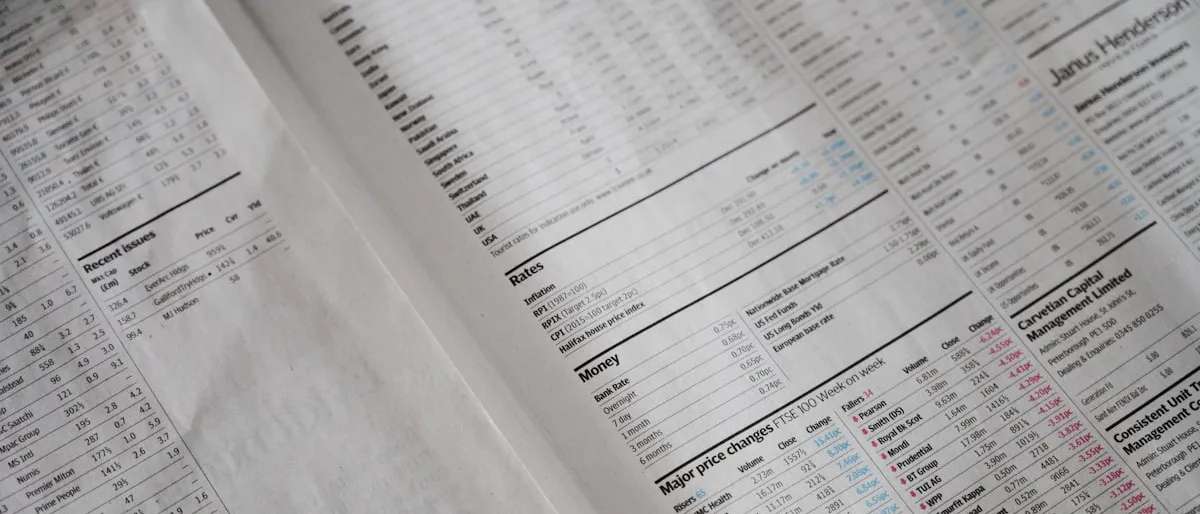 Close-up of dense financial data tables printed in a newspaper